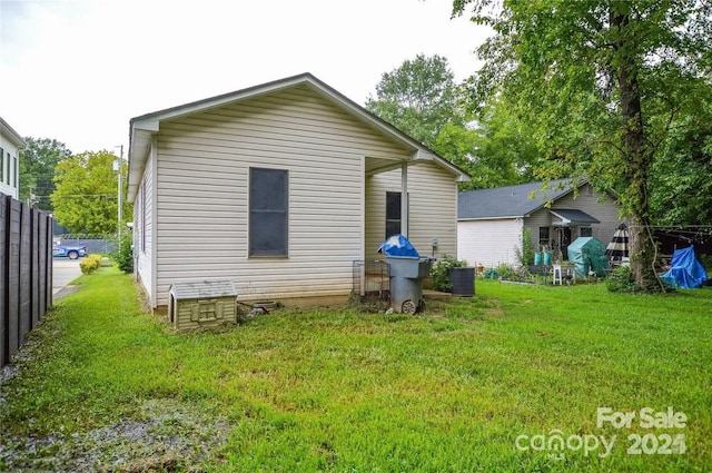 back of property featuring a lawn