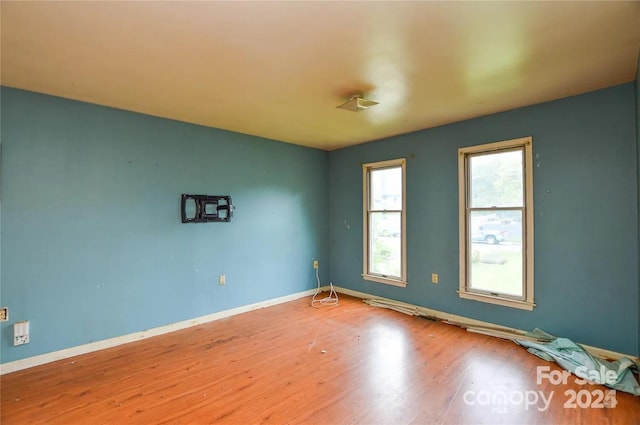 unfurnished room with wood-type flooring