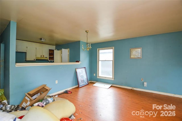 living room with a chandelier and light wood-type flooring