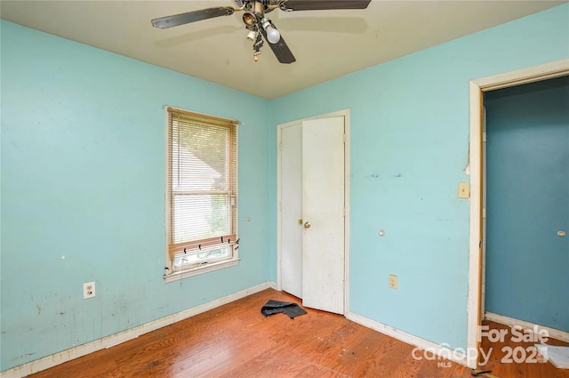 unfurnished bedroom featuring hardwood / wood-style flooring and ceiling fan