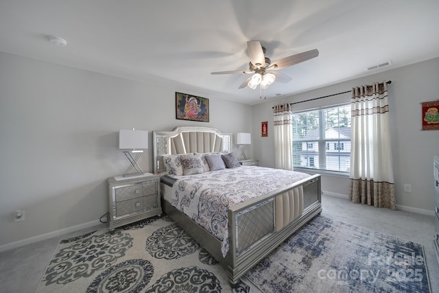 bedroom featuring visible vents, baseboards, ceiling fan, and light carpet