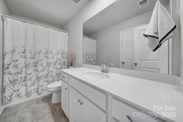 bathroom featuring visible vents, toilet, and vanity