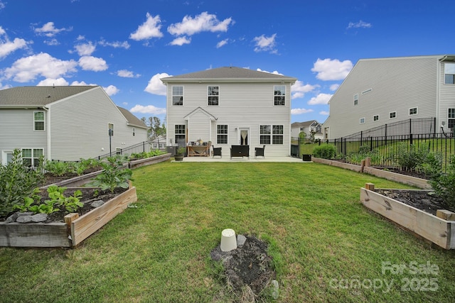 rear view of house with fence, a yard, a garden, and a patio area