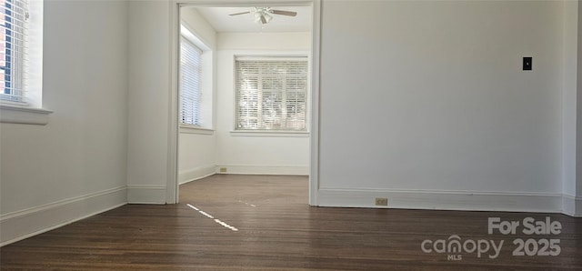 spare room featuring ceiling fan and dark hardwood / wood-style floors