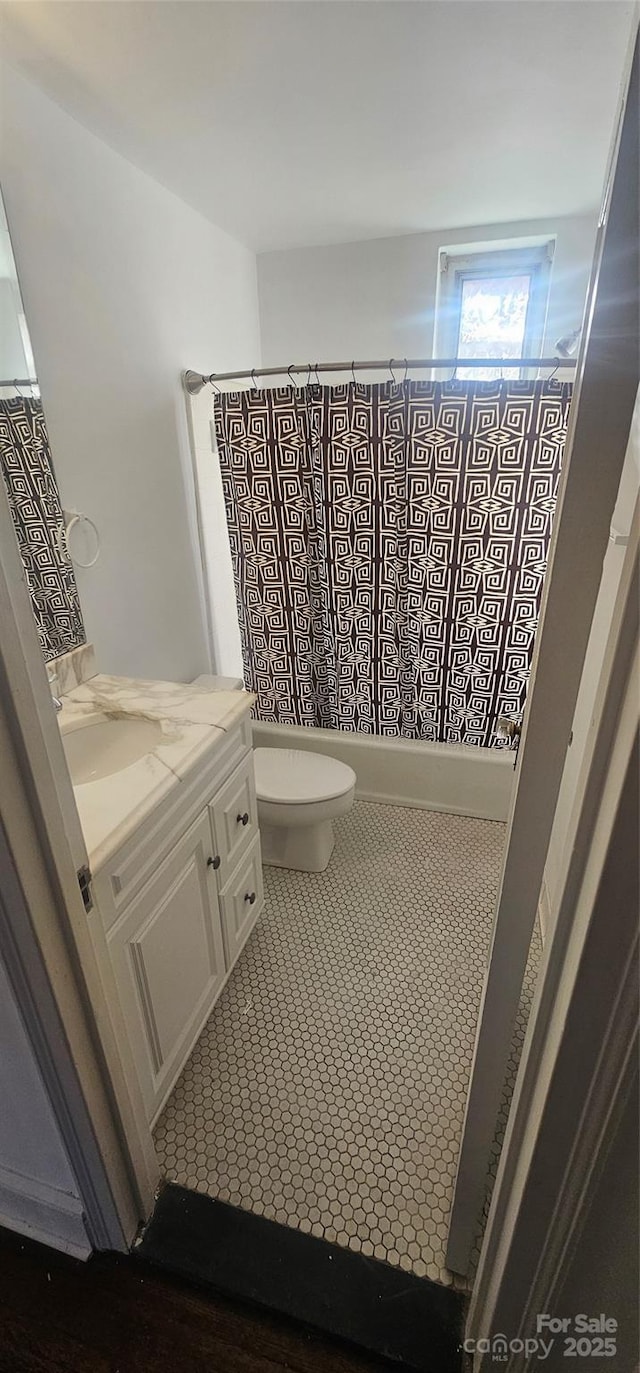 full bathroom featuring vanity, tile patterned flooring, shower / bath combo, and toilet