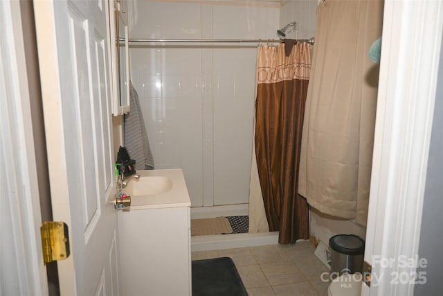 bathroom with a shower with shower curtain, vanity, and tile patterned floors