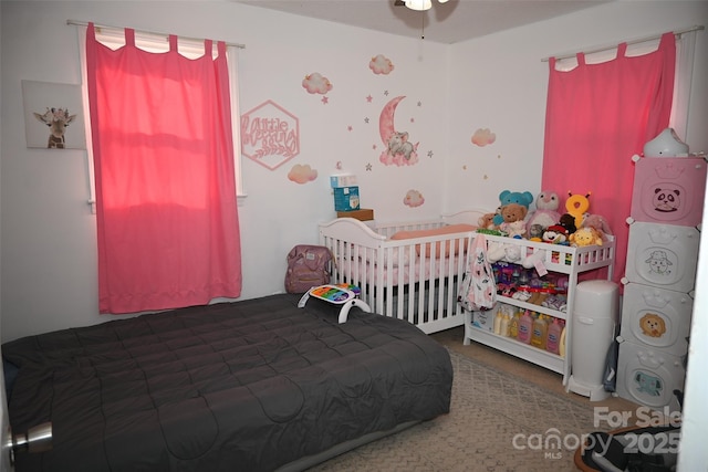 bedroom featuring a nursery area