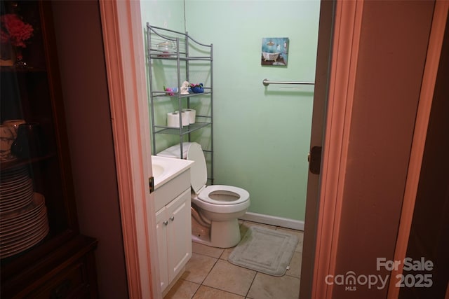 bathroom featuring toilet, tile patterned floors, and vanity