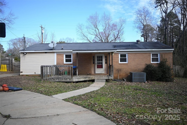 back of property with a yard and cooling unit