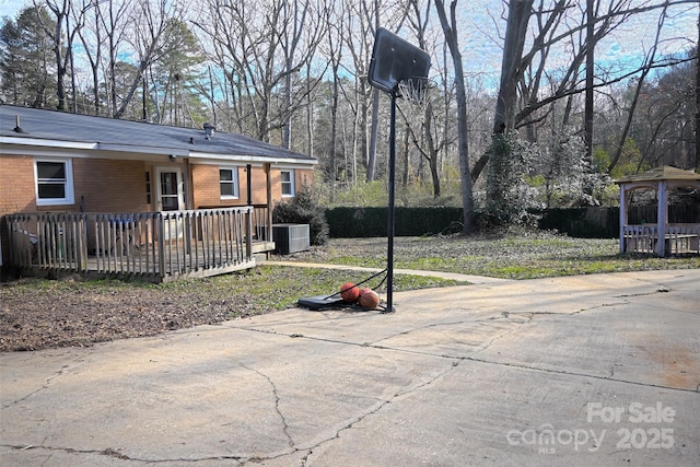 view of yard featuring a gazebo, a deck, and central AC unit