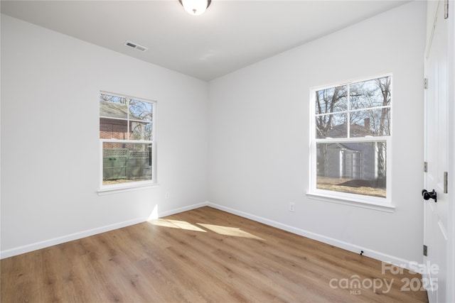 unfurnished room with light hardwood / wood-style flooring