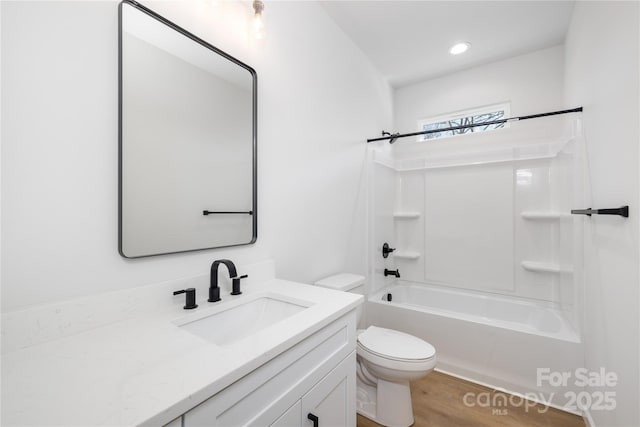 full bathroom with hardwood / wood-style flooring, shower / bathing tub combination, vanity, and toilet