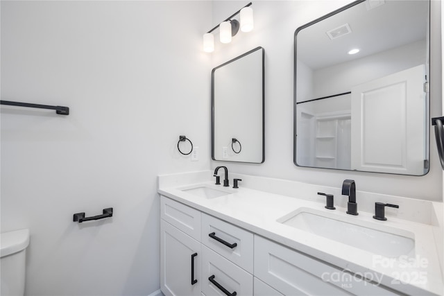 bathroom with toilet and vanity