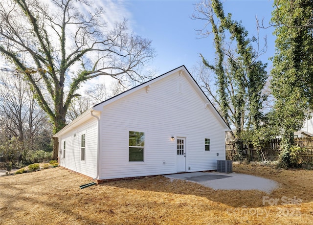 rear view of property featuring cooling unit and a patio