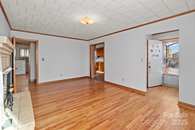 unfurnished living room featuring ornamental molding and light wood-type flooring