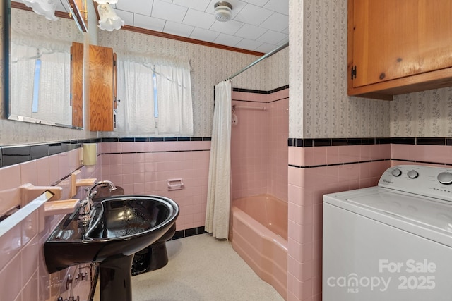 bathroom featuring washer / dryer, shower / tub combo, tile walls, and ornamental molding