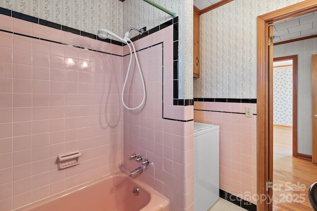 bathroom with tile walls and tiled shower / bath combo