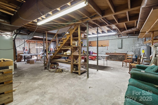 basement featuring water heater and electric panel