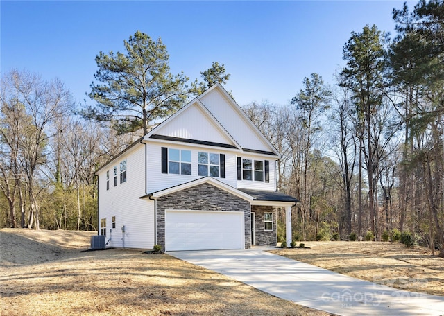 front of property with central AC unit and a garage