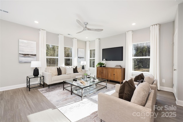 living room featuring hardwood / wood-style flooring, plenty of natural light, and ceiling fan