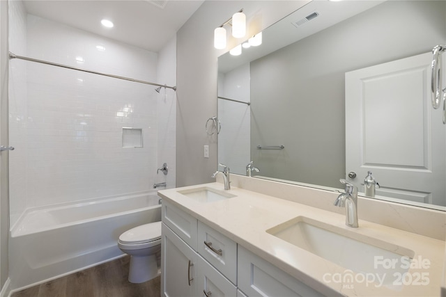 full bathroom with shower / bathing tub combination, vanity, toilet, and wood-type flooring