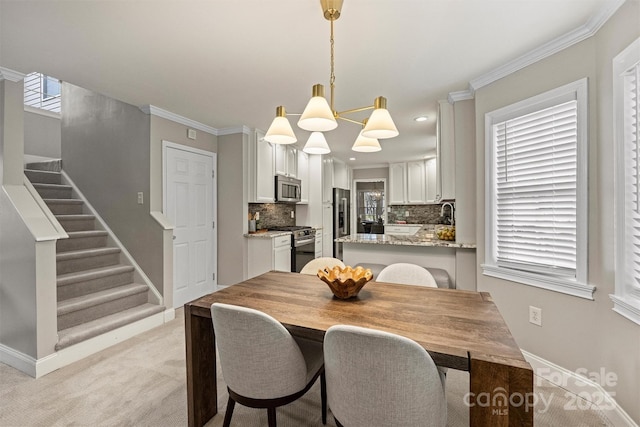 carpeted dining room featuring crown molding