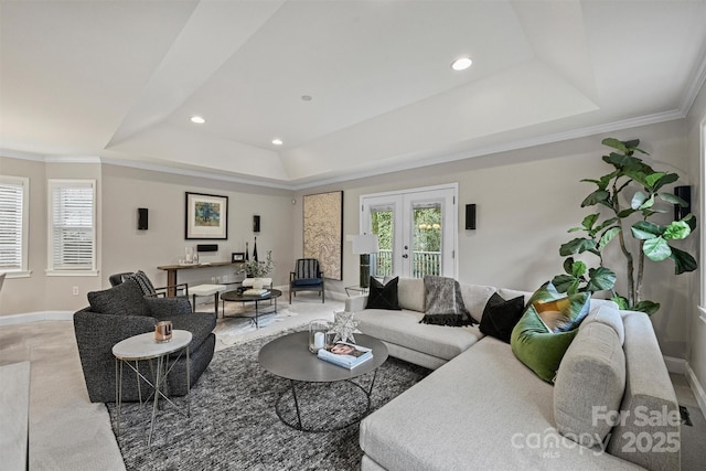 living room featuring crown molding, french doors, and a tray ceiling