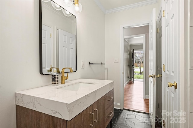 bathroom with tile patterned floors, ornamental molding, and vanity