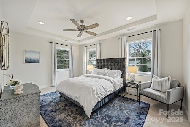 bedroom featuring ceiling fan and a raised ceiling