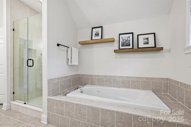 bathroom featuring tile patterned floors, separate shower and tub, and vaulted ceiling