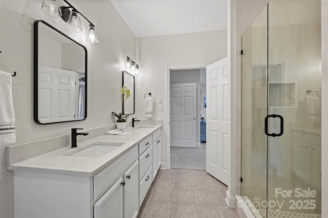 bathroom featuring tile patterned floors, vanity, and walk in shower