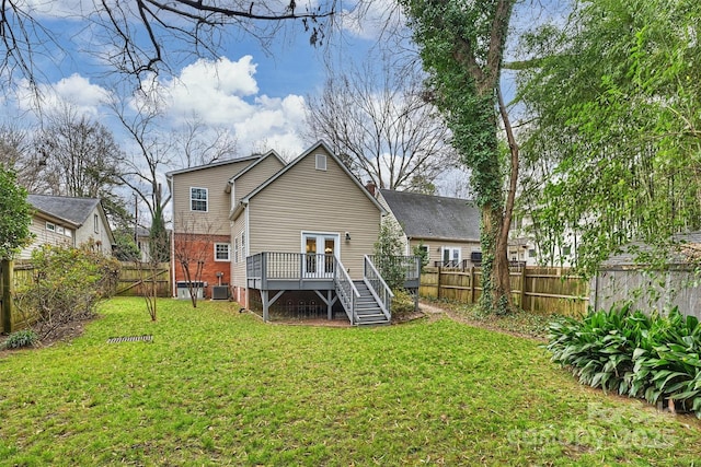 back of property with a wooden deck, french doors, and cooling unit