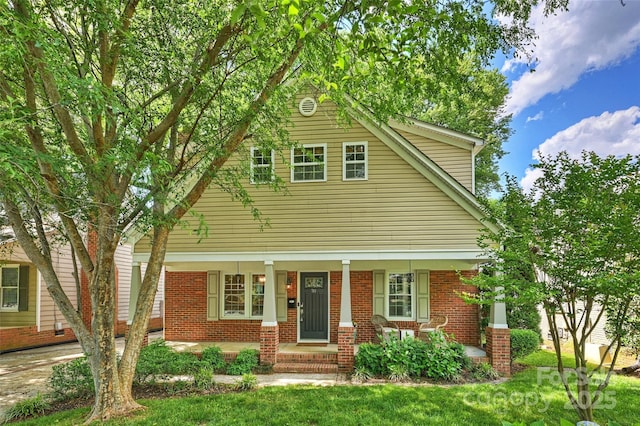 741 Mcalway Rd, Charlotte, NC 28211 - view of front of home with covered porch, brick siding, and a front lawn