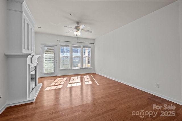 unfurnished living room featuring ceiling fan and wood-type flooring