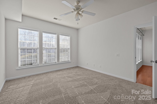 unfurnished room featuring ceiling fan and carpet floors