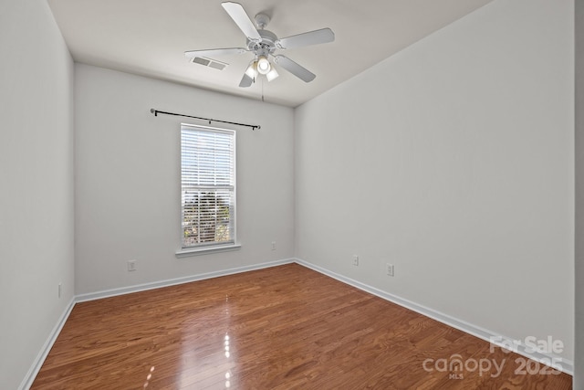 unfurnished room featuring hardwood / wood-style flooring and ceiling fan