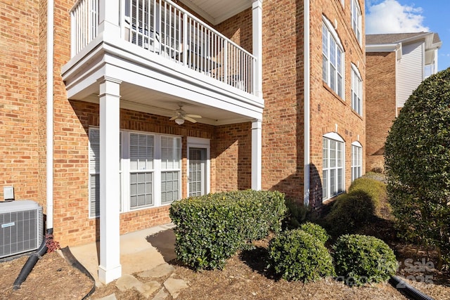 property entrance featuring a balcony, ceiling fan, and cooling unit