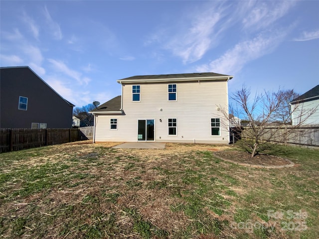 rear view of house with a lawn and a patio