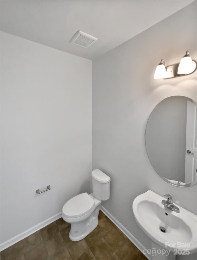 bathroom with tile patterned floors, sink, and toilet