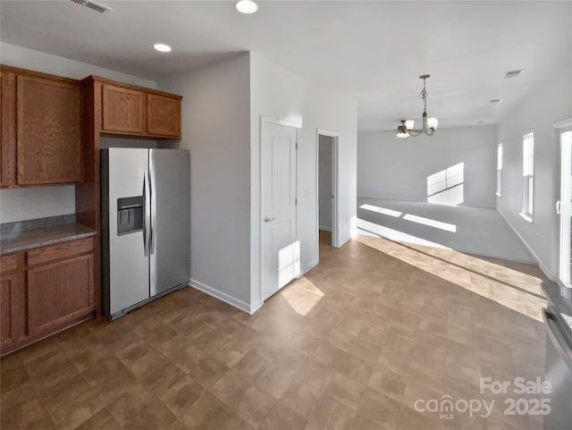 kitchen with stainless steel fridge with ice dispenser, an inviting chandelier, and hanging light fixtures