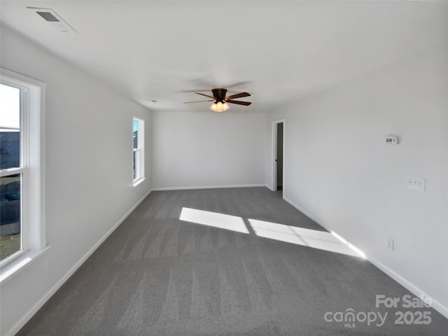 carpeted spare room featuring ceiling fan