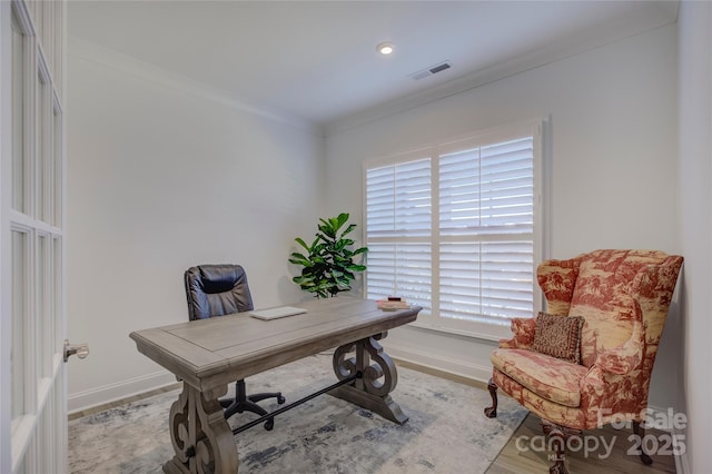 home office with ornamental molding, wood finished floors, visible vents, and baseboards