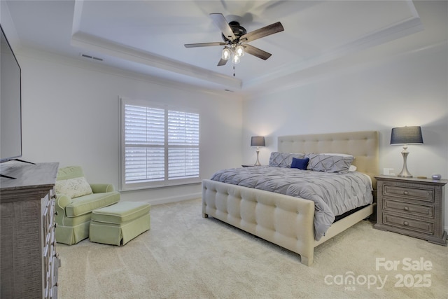 bedroom with ceiling fan, carpet, a raised ceiling, and visible vents