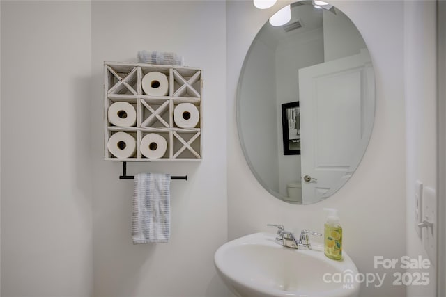 bathroom featuring a sink and visible vents