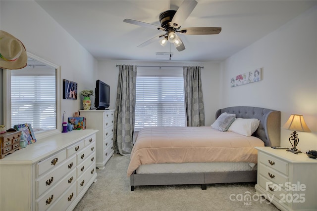 bedroom featuring a ceiling fan, light carpet, and visible vents