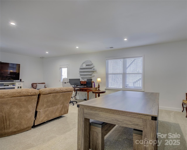 living room with light carpet, visible vents, a wealth of natural light, and recessed lighting