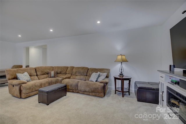 carpeted living area with baseboards and recessed lighting