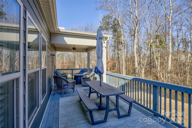 wooden terrace featuring ceiling fan