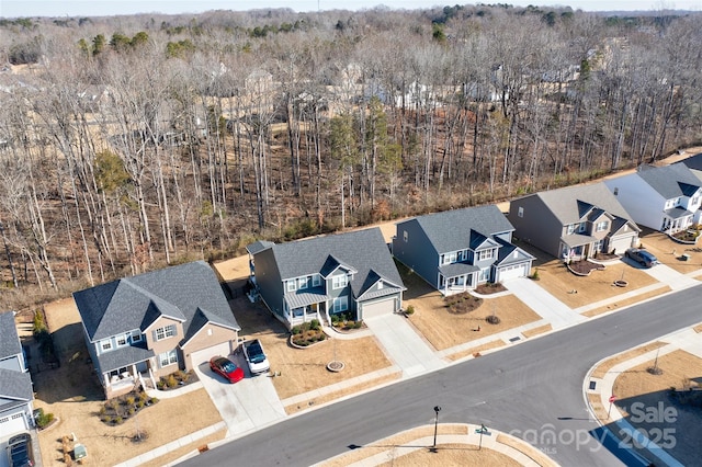 birds eye view of property with a residential view and a view of trees