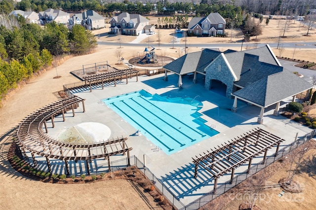 pool featuring fence and a patio